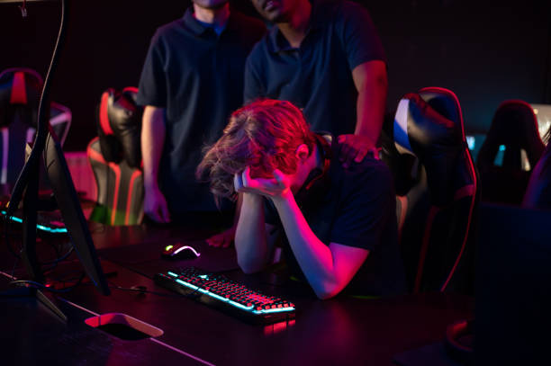 the esports rookie lost his first game and covered his face with his hands in frustration - lost first imagens e fotografias de stock