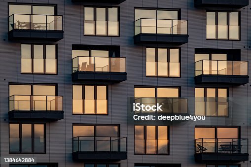 istock The evening sun is reflected in the modern glass facade with balconies DSC07504 Kopie 1384642884
