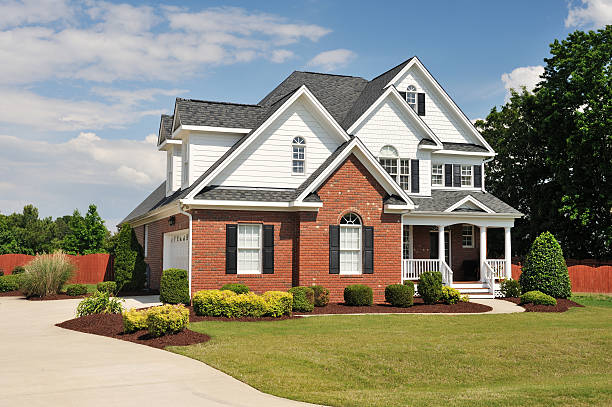 The exterior of a home with a landscaped lawn stock photo