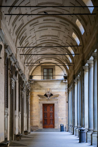 The external colonnade of the Uffizi Gallery museum in the historic heart of Florence Florence, Italy, August 11 -- A perspective view of the outdoor colonnade of the Galleria degli Uffizi Museum in Florence. The Uffizi Gallery is one of the most important museums in the world, with the Medici's family heritage and some of the major collections of paintings and sculptures by artists such as Leonardo da Vinci, Raphael and Botticelli, as well as numerous works by Giotto, Tiziano, Pontormo, Bronzino, Andrea del Sarto, Caravaggio, Dürer , Rubens, among others. Image in High Definition format. botticelli stock pictures, royalty-free photos & images