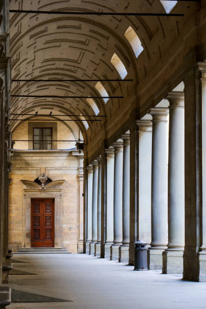 The external colonnade of the Uffizi Gallery museum in the historic heart of Florence Florence, Italy, August 11 -- A perspective view of the outdoor colonnade of the Galleria degli Uffizi Museum in Florence. The Uffizi Gallery is one of the most important museums in the world, with the Medici's family heritage and some of the major collections of paintings and sculptures by artists such as Leonardo da Vinci, Raphael and Botticelli, as well as numerous works by Giotto, Tiziano, Pontormo, Bronzino, Andrea del Sarto, Caravaggio, Dürer , Rubens, among others. Image in High Definition format. botticelli stock pictures, royalty-free photos & images