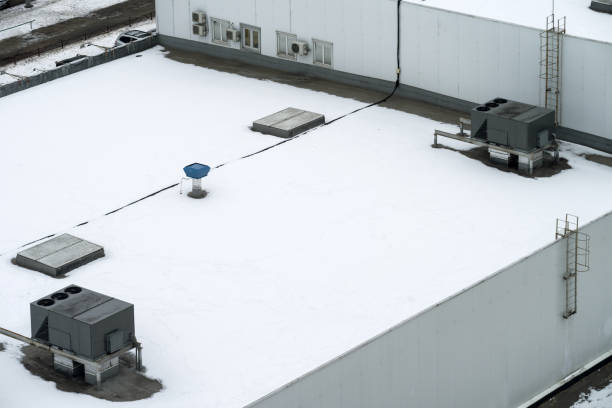 The external units of the commercial air conditioning and ventilation systems are installed on the roof of an industrial building. stock photo