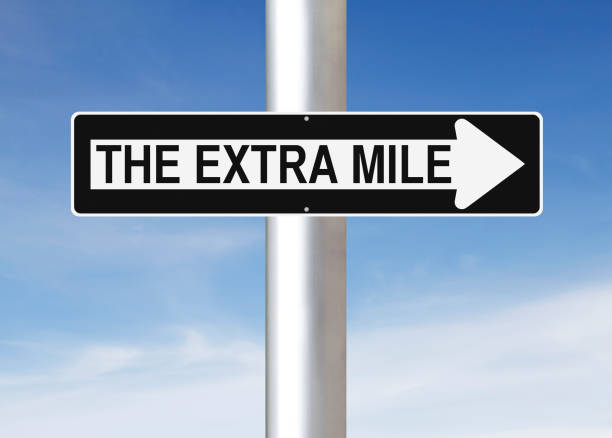 The Extra Mile This Way A modified one way sign indicating The Extra Mile dedication stock pictures, royalty-free photos & images