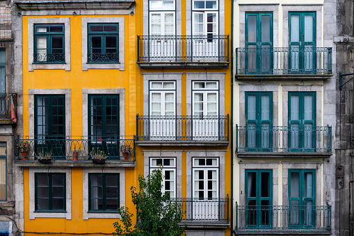 The facade of traditional building with beautiful windows at the Baixa neighborhood in the city of Porto