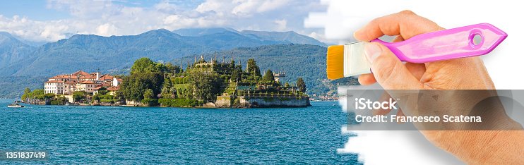 istock The famous old Isola Bella in the Lake Maggiore, one of the most famous small italian island (Italy) - concept with hand and brush 1351837419