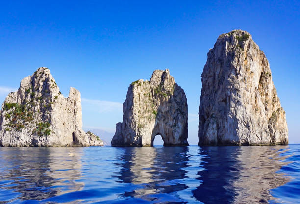 The Faragolini Rock Formations off the Island of Capri Italy. stock photo