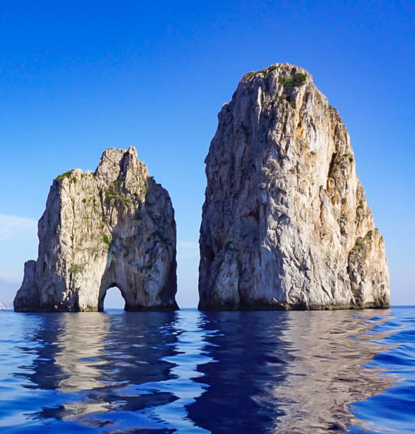 The Faragolini Rock Formations off the Island of Capri Italy. stock photo