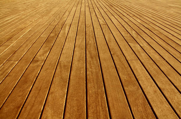 The floor is made of lacquered narrow boards of brown color.Texture or background The floor is made of lacquered narrow longitudinal boards of light brown color. Under an inclination deck stock pictures, royalty-free photos & images