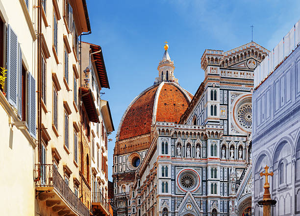 The Florence Cathedral at historic center of Florence, Italy The Cathedral of Saint Mary of the Flower (Florence Cathedral) at historic center of Florence, Tuscany, Italy. View from the Piazza San Giovanni. Dome on blue sky background. florence italy stock pictures, royalty-free photos & images