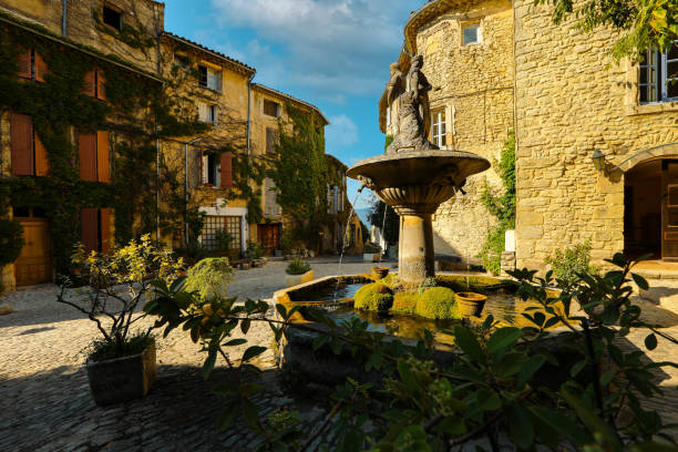 The fountain in the village square of Saignon, one of the beautiful village in France stock photo