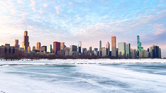 Landscape view of a frozen shore line with the Chicago skyline in the background.