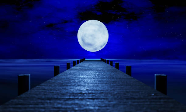The full moon at night was full of stars and a faint mist. A wooden bridge extended into the sea. Fantasy image at night, super moon, sea water wave. 3D Rendering The full moon at night was full of stars and a faint mist. A wooden bridge extended into the sea. Fantasy image at night, super moon, sea water wave. 3D Rendering full moon stock pictures, royalty-free photos & images