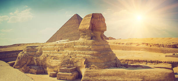 The full profile of the Great Sphinx.Giza. The full profile of the Great Sphinx with the pyramid  in the background in Giza. Egypt. Filtered image:cross processed vintage effect. sphinx stock pictures, royalty-free photos & images