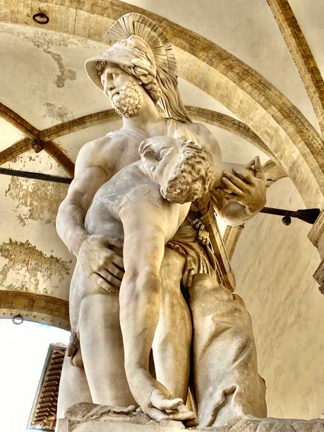 the gentle holding of pratroclus - a marble statue located in the open-air gallery loggia dei lanzi on the piazza della signoria florence, tuscany, italy. stock photo