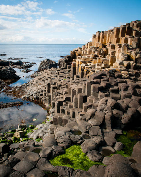 The Giant's Causeway is an area of about 40,000 interlocking basalt columns, in County Antrim on the north coast of Northern Ireland The Giant's Causeway is an area of about 40,000 interlocking basalt columns, in County Antrim on the north coast of Northern Ireland basalt column stock pictures, royalty-free photos & images