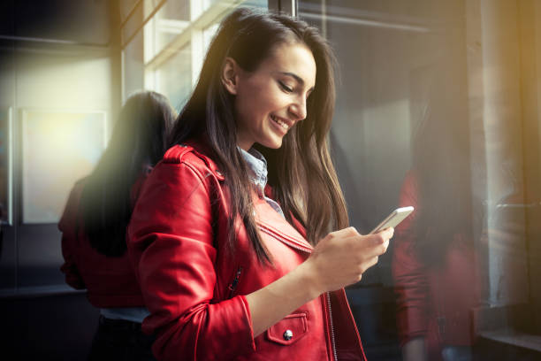 The girl in the elevator holds a shopping bags beautiful girl standing in an elevator in a shopping mall business girls stock pictures, royalty-free photos & images