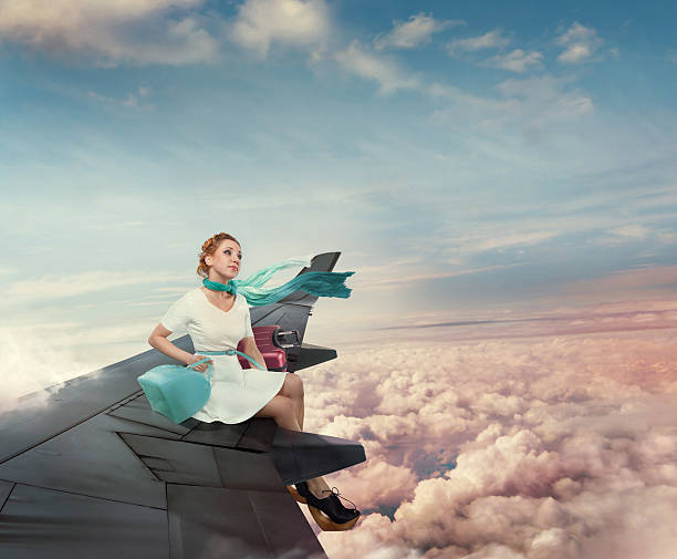The girl travel on the aircraft's wing stock photo