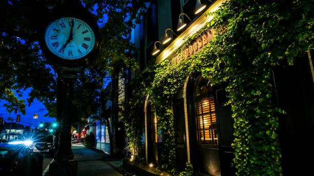 The Goose Bistro facade with sign and clock near Post Road with evening lights stock photo