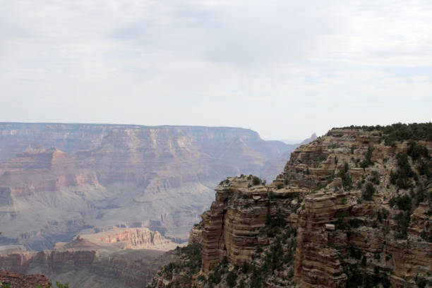 The Grand Canyon Under Cloudy Hazy Sky Landscape stock photo