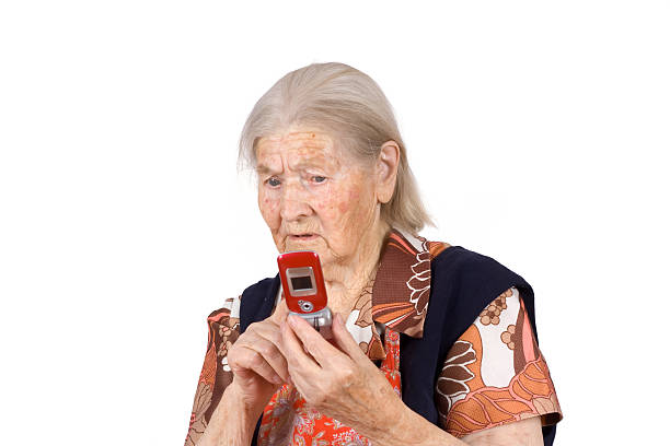 The grandmother studies phone on an isolated background