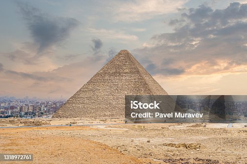 istock The great pyramid of Cheops in Cairo. The Egyptian pyramids of Giza on the background of Cairo. Miracle of light. Architectural monument. The tombs of the pharaohs. Vacation holidays background 1318972761