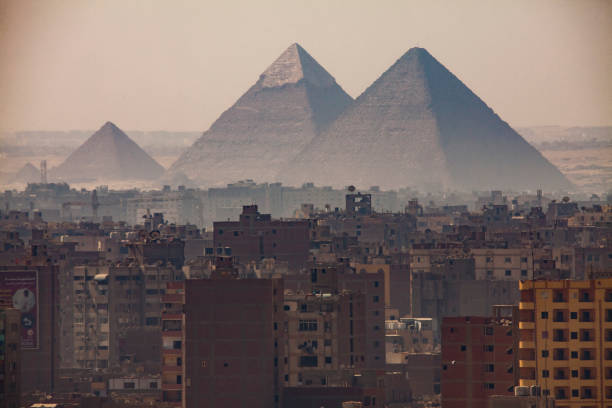 The Great Pyramids of Giza seen from Downtown Cairo with the sprawling city below The Great Pyramids of Giza is Egypt's most prized treasure. Cairo is one of the largest cities in the world and from there, you can see the great pyramids on a clear day. cairo stock pictures, royalty-free photos & images