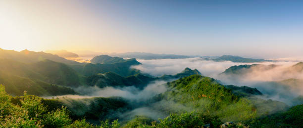 The Great Wall of Jinshanling in the Mist The Great Wall of Jinshanling in the Mist jinshangling stock pictures, royalty-free photos & images