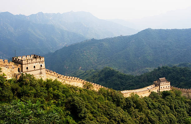 The Great Wall surrounded by trees China - Great Wall in Mutianyu mutianyu stock pictures, royalty-free photos & images