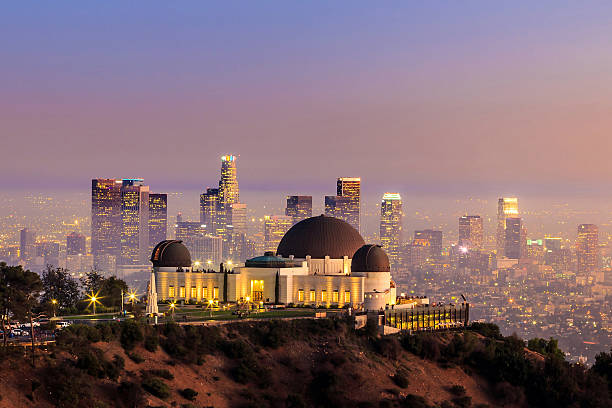 The Griffith Observatory and Los Angeles city skyline The Griffith Observatory and Los Angeles city skyline at twilight observatory stock pictures, royalty-free photos & images