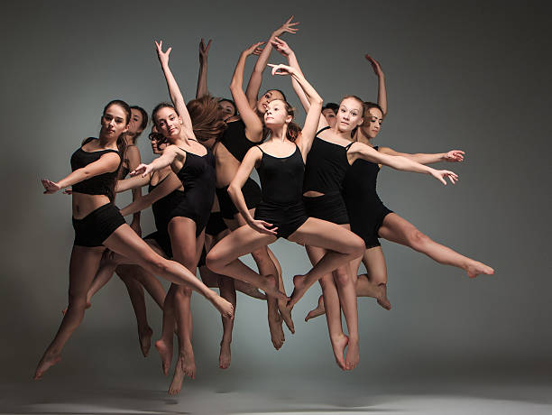 The group of modern ballet dancers The group of modern ballet dancers jumping on gray background art schools stock pictures, royalty-free photos & images