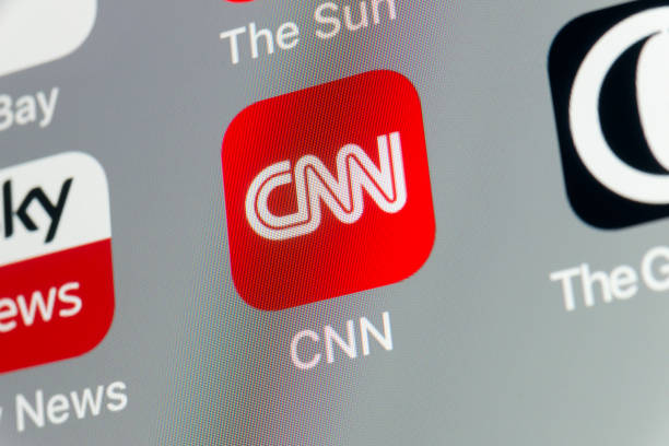 CNN, The Guardian, Sky News and other cellphone Apps on iPhone screen stock photo