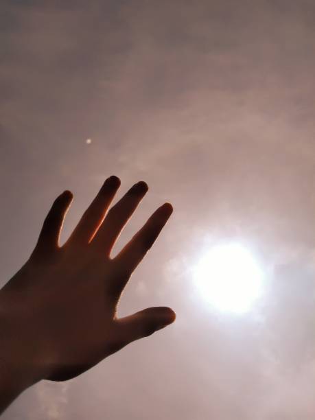 The hand that demonstrates the achievement of the sky stock photo
