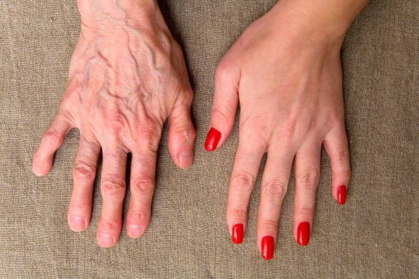 The hands of a young and elderly women. stock photo