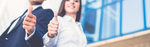 The happy business man and woman thumb up stock photo