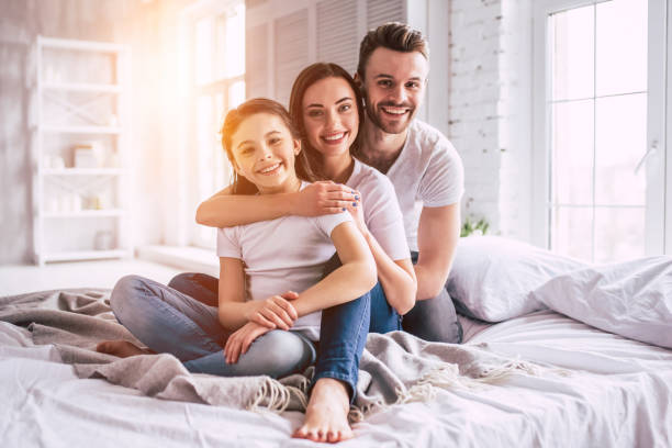 The happy family sitting on the bed The happy family sitting on the bed beautiful polish girls stock pictures, royalty-free photos & images