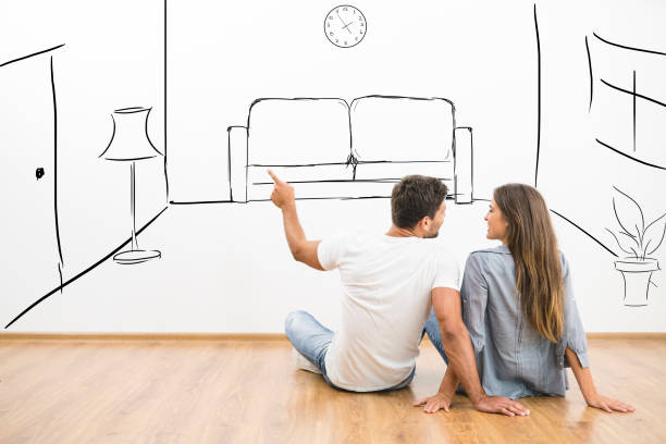 The happy man and woman dream near virtual room on the wall stock photo