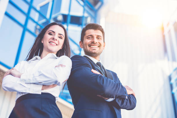 The happy man and woman stand on the background of the office center stock photo