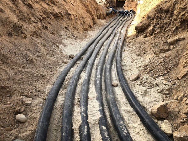 The high voltage electrical cable is laid in a trench The high voltage electrical cable is laid in a trench. underground stock pictures, royalty-free photos & images