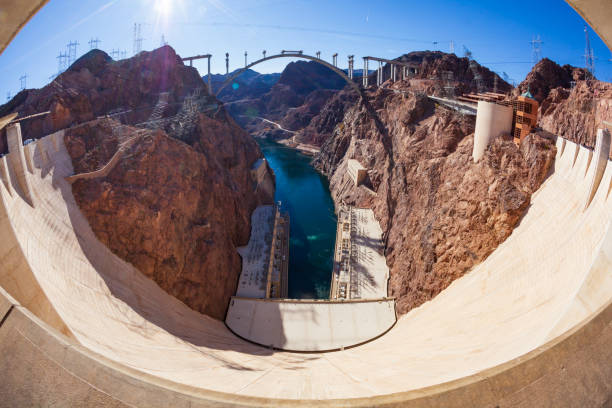 The Hoover Dam along the Colorado River, between Arizona and Nevada and construction of the Mike O'Callaghan Pat Tillman Memorial Bridge, January 2010 during a clear and sunny day. stock photo