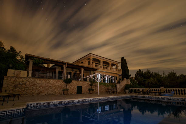 The house under cloudy night sky stock photo
