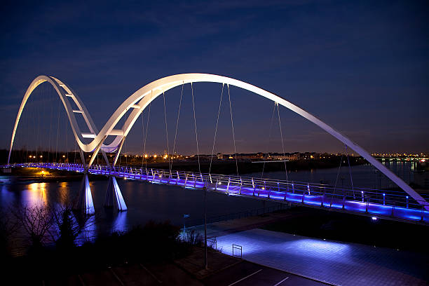 The Infinity Bridge, Stockton-on-Tees, England Night view of the Infinity Bridge, a public pedestrian and cycle footbridge across the River Tees in the borough of Stockton-on-Tees in the north east of England. county durham england stock pictures, royalty-free photos & images