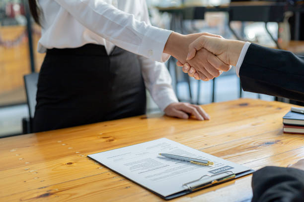The job interviewer and the job applicant are shaking hands after the job interview is finished. The concept of recruiting employees to work in the company, vacant positions. stock photo