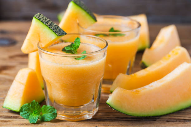 The juice of melon with mint in a glass jar on the table.Hami melon stock photo