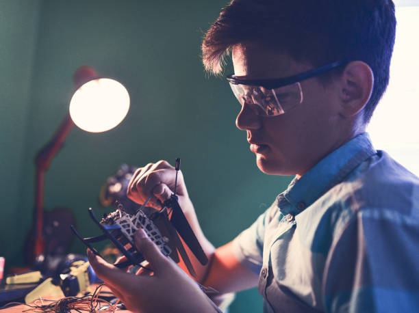 The kid loves to fix things.has a passion for electronics. stock photo