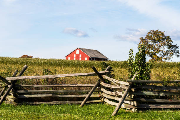 The Klingle Farm in the distance with a wooden fence at Gettysburg, Pennsylvania, USA stock photo