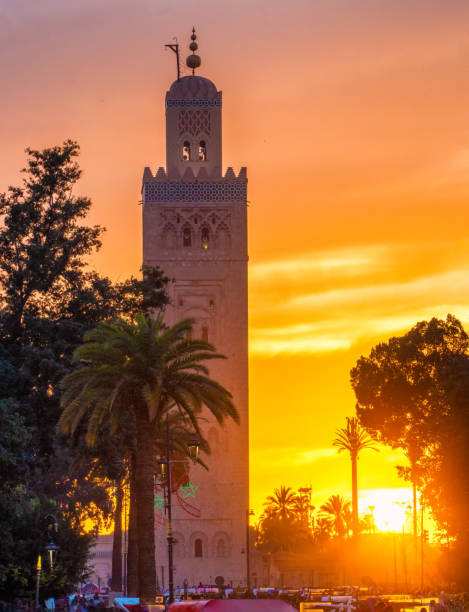 The Koutoubia Mosque at sunset with shot from Jamaa el-Fnaa square in the Marrakech district of the medina. Perfect shot for travel, holidays and vacations. The Koutoubia Mosque at sunset with shot from Jamaa el-Fnaa square in the Marrakech district of the medina. Perfect shot for travel, holidays and vacations. koutoubia mosque stock pictures, royalty-free photos & images