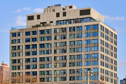 Brooklyn, NY - March 10 2021: The facade of the new 98 Front St apartment building (2019) is shaped like stacked cubes. An 11 story residential condominium building was designed by ODA Architecture and developed by HopeStreet.