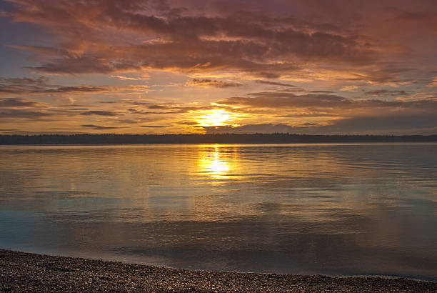 Sunset Over Puget Sound The landscapes and seascapes of Puget Sound are a constant source of inspiration for photographers. This picture of a sunset was photographed from Brown's Point Park near Tacoma, Washington State, USA. jeff goulden puget sound stock pictures, royalty-free photos & images