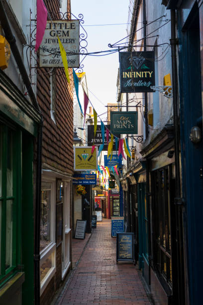 The Lanes in Brighton, UK BRIGHTON, UK - MAY 4TH 2018: A view down one of the narrow streets of The Lanes in the historic quarter of the city of Brighton in Sussex, UK, on 4th May 2018. brighton stock pictures, royalty-free photos & images