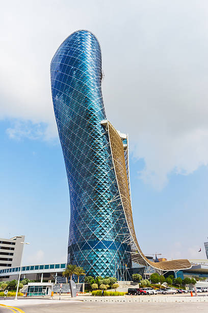 The large blue Capital gate tower ABU DHABI, UAE - NOVEMBER 5: The Capital Gate Tower on the November 5, 2013 in Abu Dhabi, This is certified as the World's Furthest Leaning Manmade in the world. it is in the heart of the business area. abu dhabi stock pictures, royalty-free photos & images
